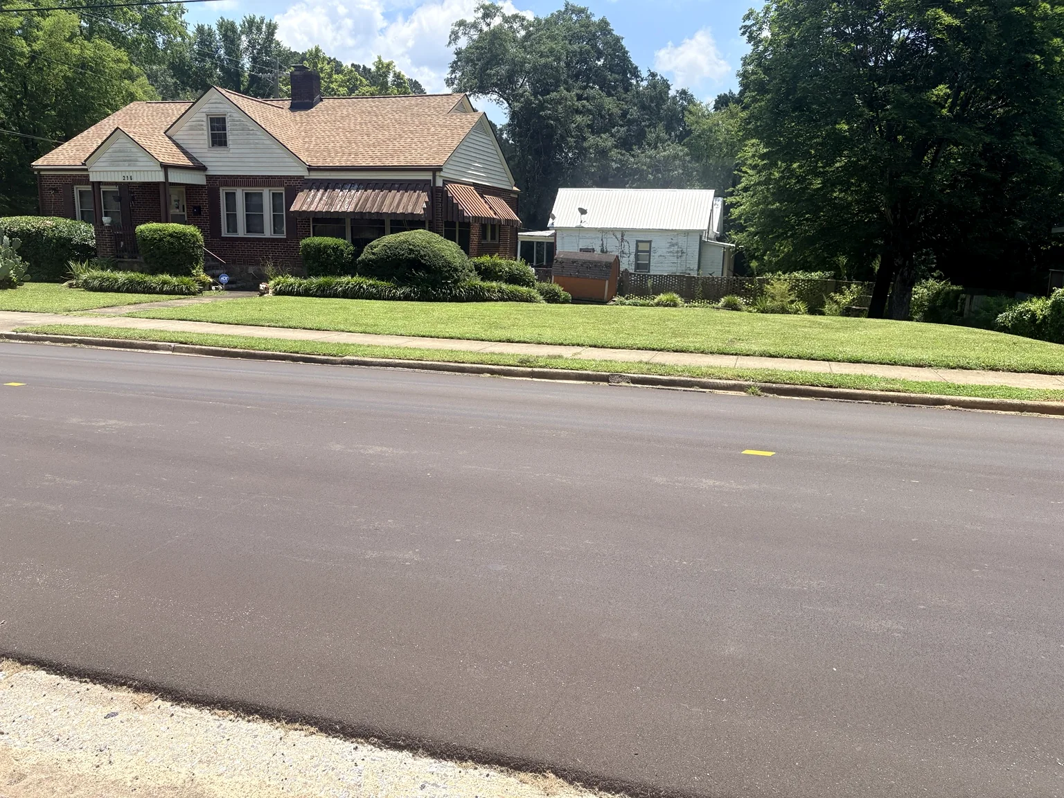 Maintained lawn in front of a brick home