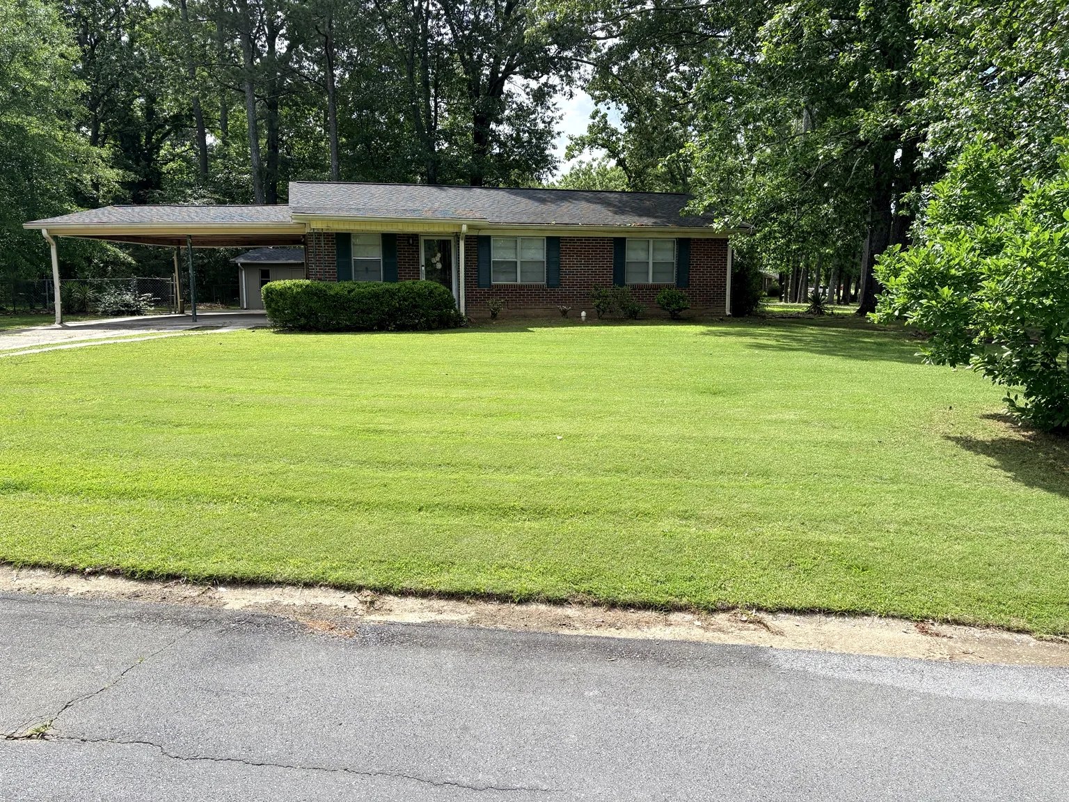 Wide freshly maintained front lawn